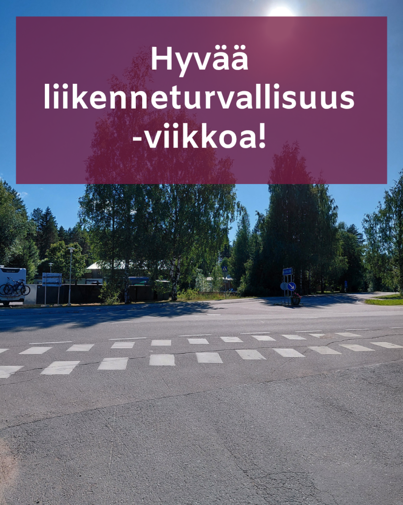 Kuvassa suojatie Kirkonkylältä. Kunnan brändiväreillä teksti "Hyvää liikenneturvallisuusviikkoa!"